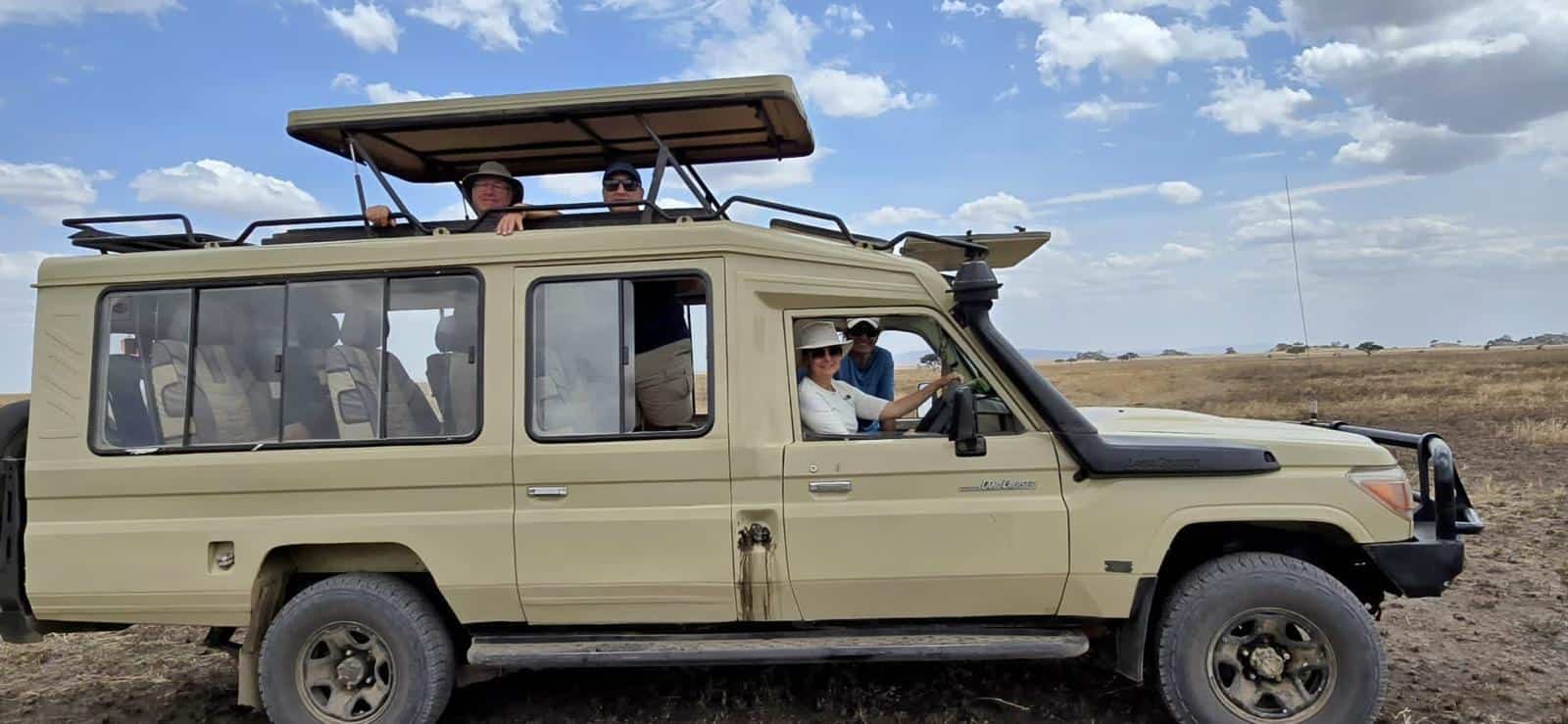 Tourist on a safari in Kenya on a Safari Land Cruiser