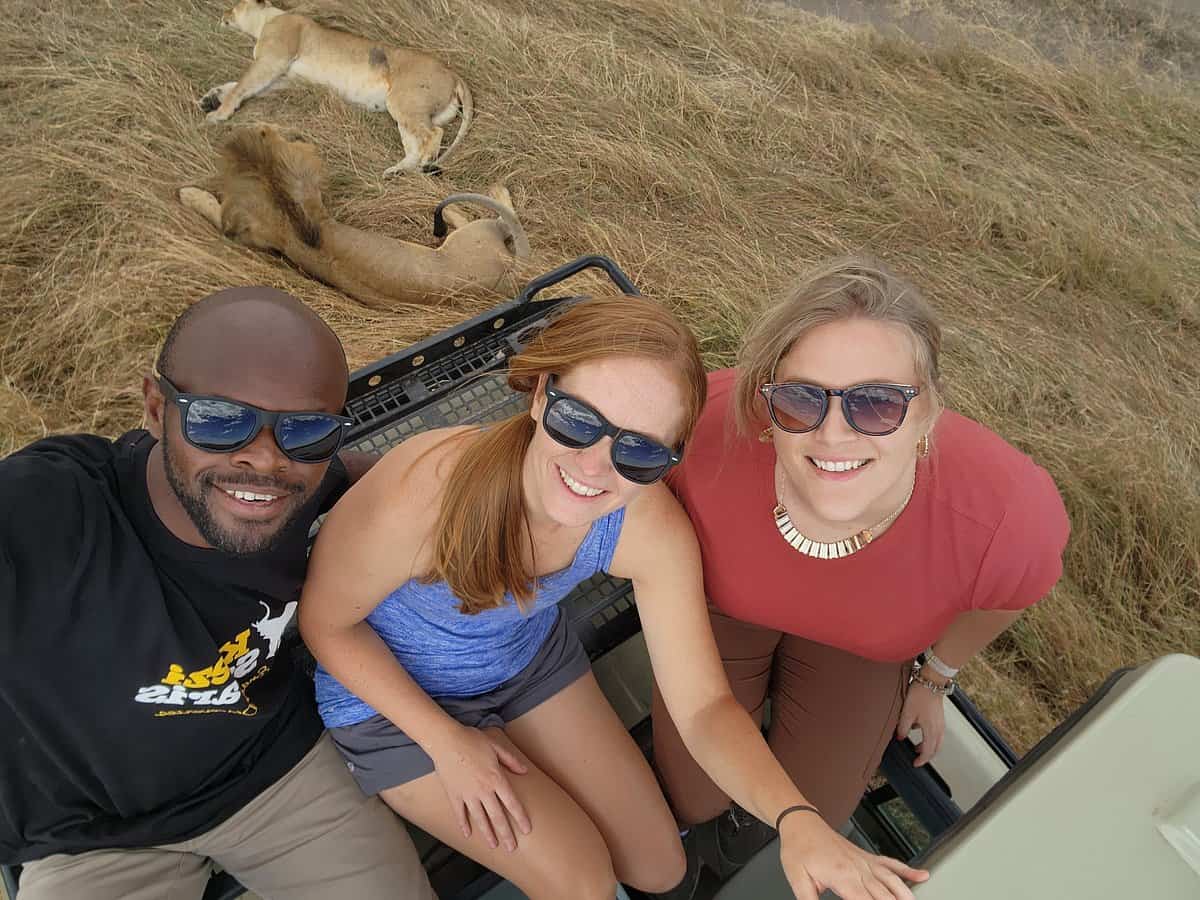 Kwezi Safari guide and guest on a game drive in Maasai Mara